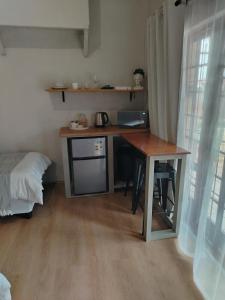 a desk in a room with a table and a bed at KarooRus in Burgersdorp
