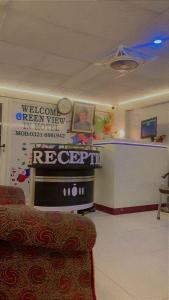 a waiting room with a sign on the wall at Green View Inn Hotel in Lahore