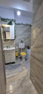 a bathroom with a toilet and a sink at Marble Studio in Bucharest +16 photos