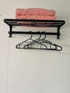 a towel rack in a bathroom with two towels at Singgah Dusun Zahra in Kampong Perak