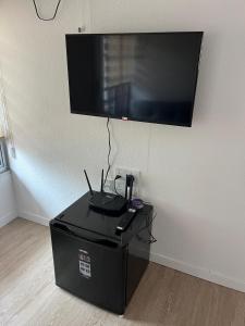 a flat screen tv hanging on a wall at Singgah Dusun Zahra in Kampong Perak