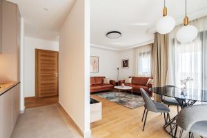 a living room and dining room with a table and chairs at APART 28 - Premium Suites in Podgorica