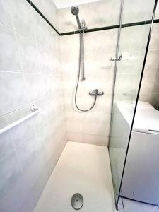 a bathroom with a shower and a toilet and a sink at Résidence thermale de Vernet-les-Bains - balcon, ascenseur, wifi, parking in Vernet-les-Bains +30 photos
