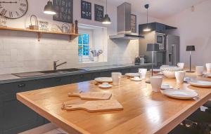 a kitchen with a wooden table with utensils on it at Luxueuse Maison Avec Piscine in Cravans