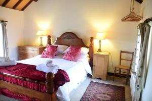 a bedroom with a bed with a teddy bear on it at Hen Gamdda Fawr in Llanallgo