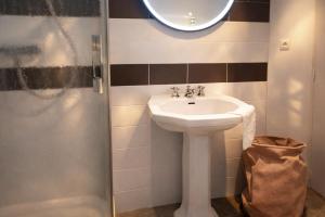 a bathroom with a sink and a mirror at Pomme d'Happy in Autheux +7 photos