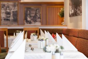 a table with a white table cloth and flowers on it at Hotel Bischofsmütze in Filzmoos