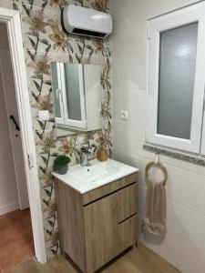 a bathroom with a sink and a mirror at Casinhas à Beira Rio in Penacova +22 photos