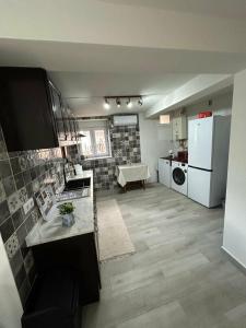 a kitchen and living room with a white refrigerator at Casinhas à Beira Rio in Penacova