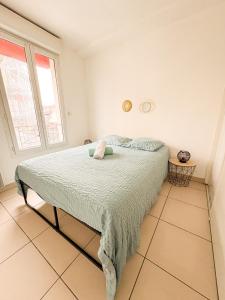 a bedroom with a bed in a room with a window at À Quelques pas de la gare - Duplex in Sartrouville