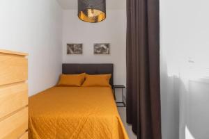 a bedroom with a bed with a yellow blanket at Nice Bungalow with Two Bedrooms in Adeje +25 photos