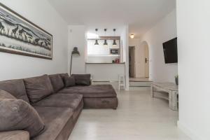 a living room with a brown couch and a table at Nice Bungalow with Two Bedrooms in Adeje