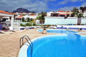 a swimming pool in a resort with mountains in the background at Nice Bungalow with Two Bedrooms in Adeje