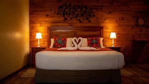 a bedroom with a large bed with two lamps at Refugio del Maipo Lodge in San José de Maipo +44 photos