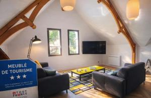 a living room with two couches and a table at Pomme d'Happy in Autheux