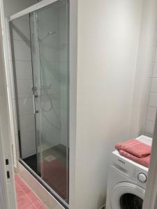 a bathroom with a shower and a washing machine at Eiffel in Haubourdin +19 photos