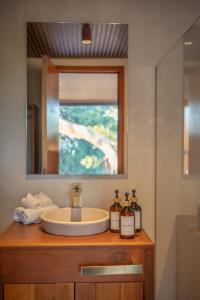 a bathroom counter with a sink and a mirror at Tregua Bacalar in Bacalar
