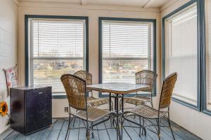 a dining room with a table and chairs and windows at 3 Mi to Dtwn Monticello! Waterfront Studio Getaway in Monticello