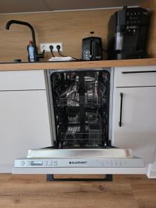 a dishwasher with its door open in a kitchen at Cozy downtown studio in Schwäbisch Hall