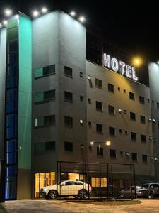 a hotel with a car parked in front of it at Hotel Accordes in Campo Grande