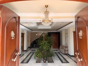 a hallway with a chandelier and potted plants at CASABA - Boutique - Torre del Mar in Torre del Mar