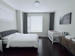 a bedroom with a bed and a crib in it at Spacious Home in Richmond in Richmond