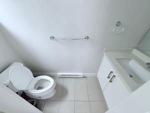 a white bathroom with a toilet and a sink at Spacious Home in Richmond in Richmond