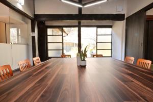 a large wooden table in a room with chairs at 愛敬家 in Mobara +60 photos
