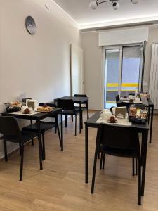 a room with tables and chairs with food on them at Sogni in Suites in Bari +58 photos