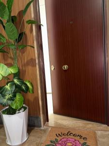 a plant in a white pot next to a door at Sogni in Suites in Bari