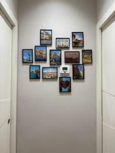 a group of pictures on a white wall at Sogni in Suites in Bari