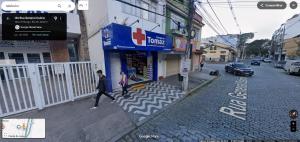 a man and a woman walking down a street at Ebeneze in Nova Friburgo