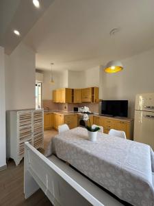 a kitchen with a white table and a kitchen with a kitchen at Appartamento Bixio sul porto in Sanremo