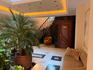 a living room with a couch and palm trees at CASABA - Boutique - Torre del Mar in Torre del Mar