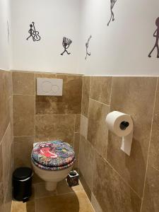 a bathroom with a toilet and a roll of toilet paper at Studio Music Blue - Bourgoin Centre in Bourgoin