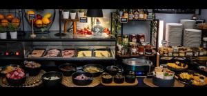 a buffet with many different types of food on display at DORMERO Hotel Xanten in Xanten