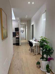 an office with a desk and a table with a plant at Sogni in Suites in Bari