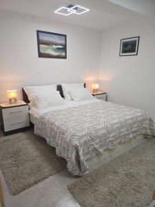 a bedroom with a large bed with two night stands at Infinity Blue Korčula in Korčula +24 photos