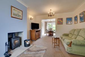 a living room with a couch and a fireplace at 3 Bed in Ravenscar oc-sa397 in Ravenscar