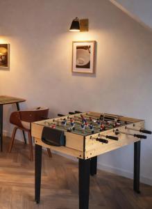 a table with a chessboard on top of it at Pomme d'Happy - 1 chambre in Autheux +6 photos