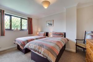 a bedroom with two beds and a chair at 3 Bed in Ravenscar oc-sa397 in Ravenscar