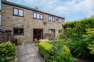 a stone house with a garden in front of it at 3 Bed in Ravenscar oc-sa397 in Ravenscar