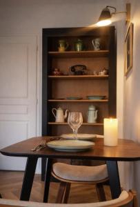 a dining room table with a candle and a candle at Pomme d'Happy - 1 chambre in Autheux