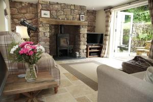 a living room with a couch and a fireplace at 4 Bed in Gower oc-hh471 in Llanmadoc