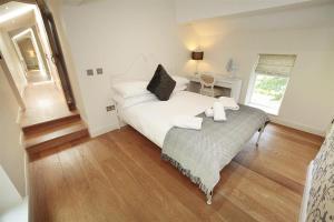 a bedroom with a large white bed and a table at 4 Bed in Gower oc-hh471 in Llanmadoc