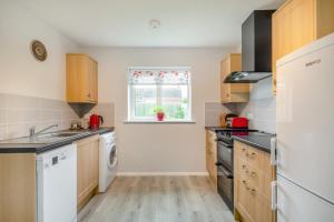 a kitchen with white appliances and a window at 2 Bed in Reedham oc-2378 in Haddiscoe