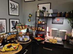 a buffet with food on a counter in a room at DORMERO Hotel Xanten in Xanten