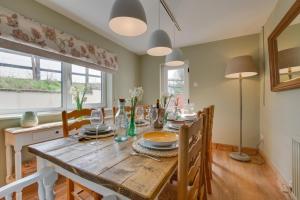 a dining room with a wooden table and chairs at 4 Bed in St. Wenn oc-p00886 in Saint Wenn