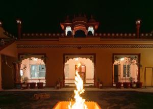 a fire fountain in front of a building at night at Fort Jangaldhar in Bikaner