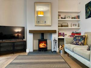 a living room with a couch and a fireplace at 3 Bed in Winterton-on-Sea oc-2205 in Winterton-on-Sea